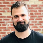 Man with a beard looking at the camera