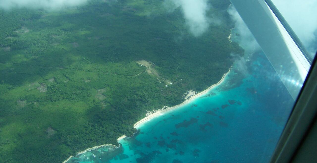 Wabunun from the air, two rows of houses aligned along the beach running east to west.