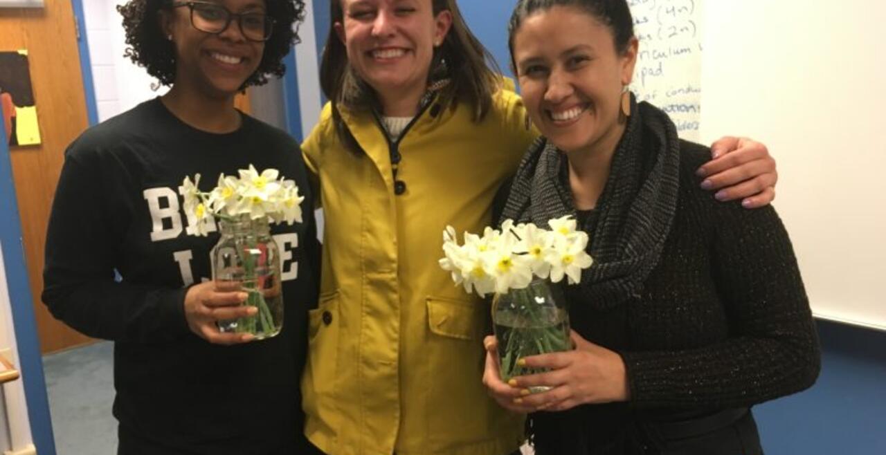 A photo of Janelle Billingsley, Audrey Wittrup, and Andrea Negrete holding flowers