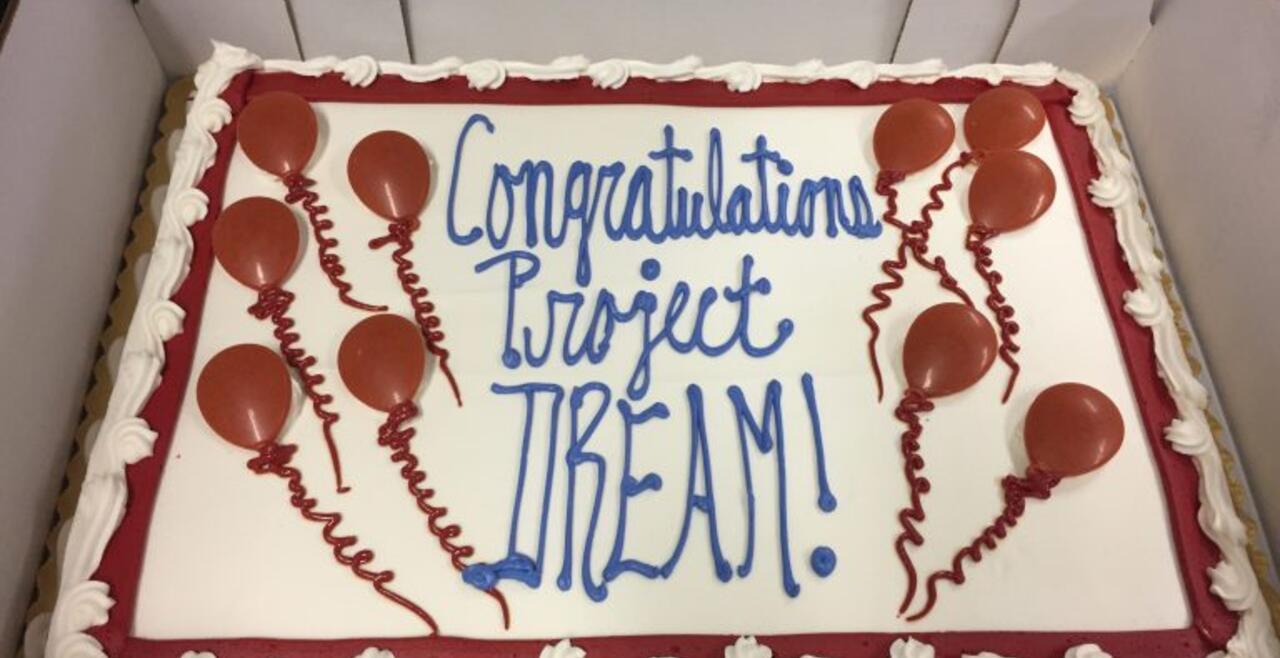 A photo of a sheet cake that says Congratulations Project Dream