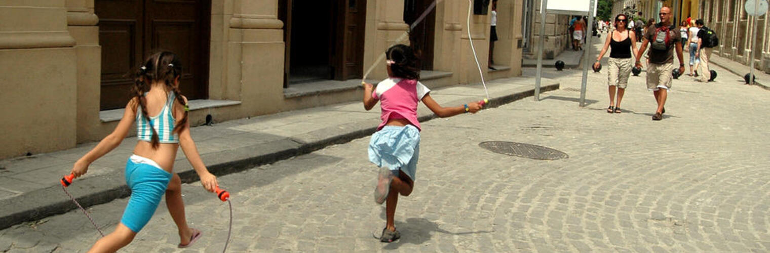A photo of children jumping rope in the street