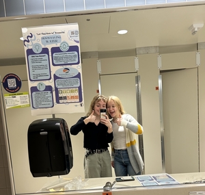 Picture of Liv and Caroline hanging up Let This Sink In Journals